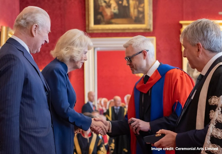 king charles and queen camilla presenting prof luke bisby and prof peter mathieson with award